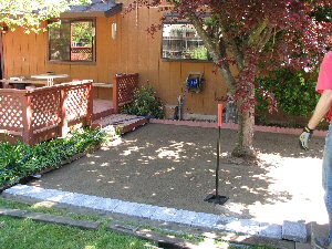 Bob beginning to lay out pavers on tamped sand