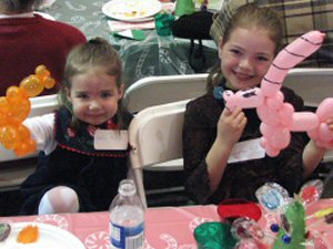 Katelyn and Samantha with their balloon pony and unicorn