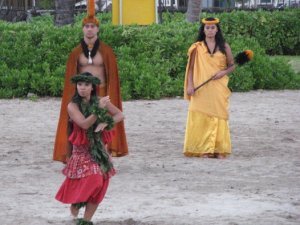 The king and queen being entertained by a hula dancer