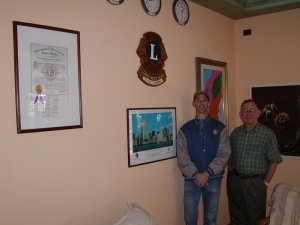 Bob and Al, Ukiah Host Lions' Club members, posing next to the Orbetello Lions Club plaques