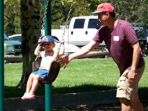 Nate and his daughter on the swings