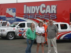 Sara, Trish and Steve pose near the safety trucks